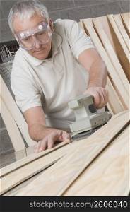 Carpenter planing a wooden plank