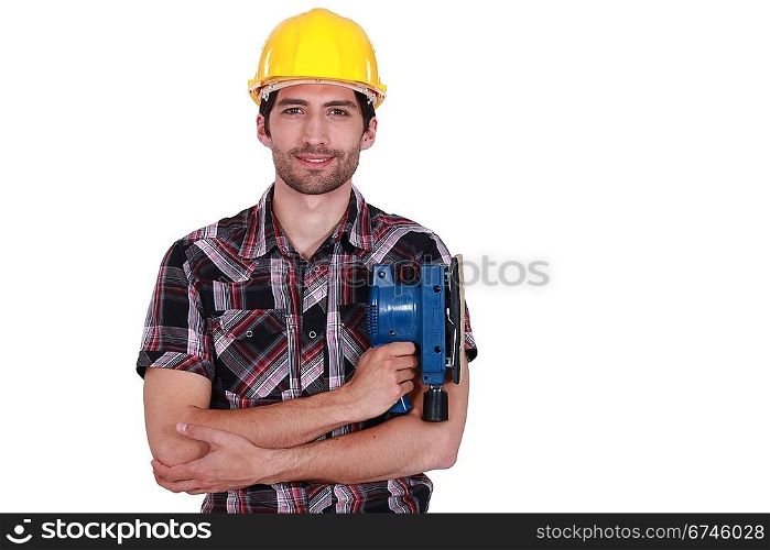 Carpenter posing with power sander
