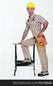 Carpenter stood by work-bench
