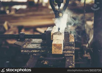 Carpenter tools on wooden table with sawdust. Carpenter workplac. Close-up of carpenter cutting a wooden plank. Close-up of carpenter cutting a wooden plank