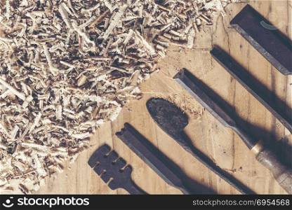 Carpenter tools on wooden table with sawdust. Carpenter workplace top view