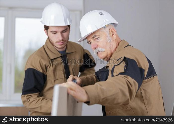 carpenter trainee learning with boss