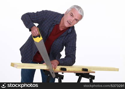 Carpenter using a handsaw