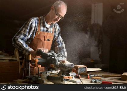 Carpenter using an electric circular saw, cutting a piece of wood. High quality photo.. Carpenter using an electric circular saw, cutting a piece of wood.