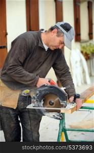 Carpenter using electric saw