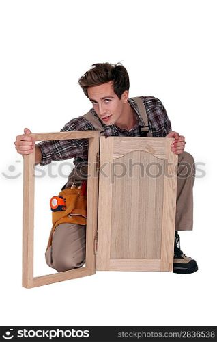 Carpenter with a cupboard door