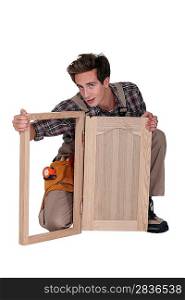 Carpenter with a cupboard door