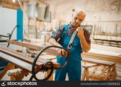 Carpenter, wooden bench manufacturing, woodworking, lumber industry, carpentry. Wood processing on furniture factory, production of products of natural materials, joiner job