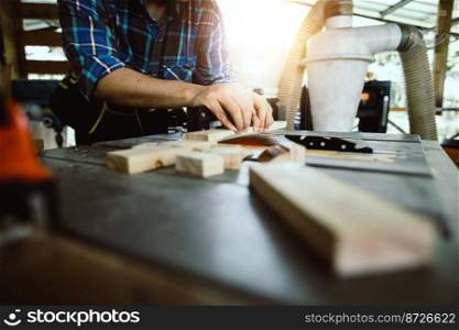 carpenter worker saws a wooden beam
