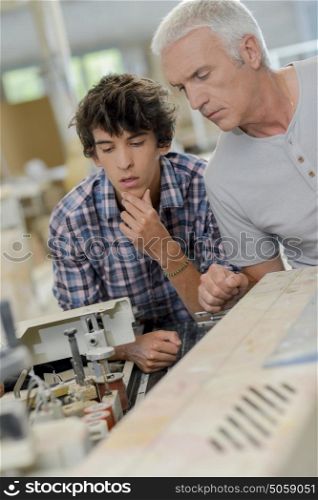 Carpenter working with apprentice