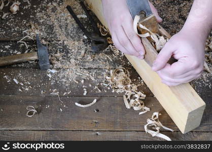 Carpenter working wood on the workbench carpentry.