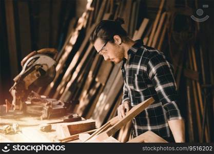 Carpenter young man hand made crafting furniture in DIY wood workshop. Caucasian authentic real wooden job worker.