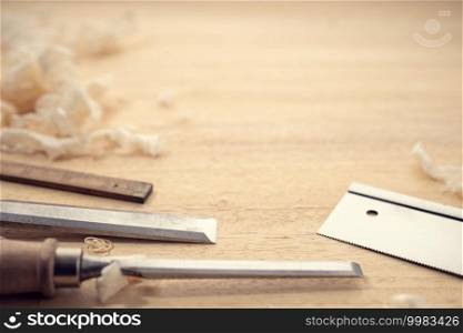 Carpentry or woodworking background with copy space. Carpentry tools and wood shavings on a table. Woodworking, craftsmanship and handwork concept