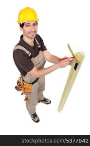 Carpinter measuring plank of wood