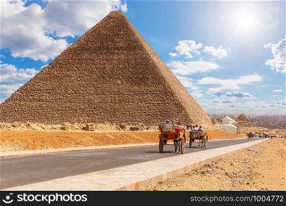 Carriage on the road near the Pyramid of Cheops, Giza, Egypt.. Carriage on the road near the Pyramid of Cheops, Giza, Egypt