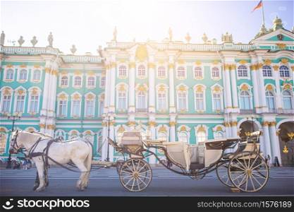 Carriage with horses on background of one of the largest and historical museums in Russia and the world. The Palace Square in St Petersburg inRussia