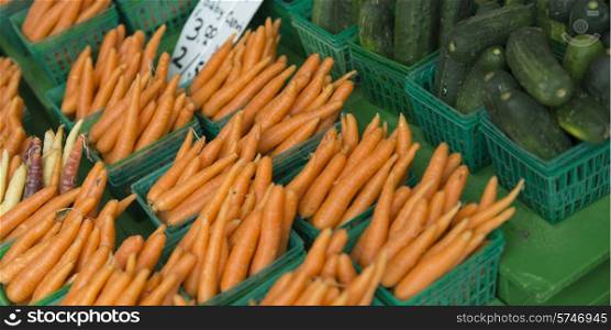 Carrot and cucumbers for sale at a market stall, Byward Market, Ottawa, Ontario, Canada