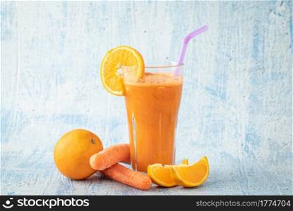 carrot and orange fresh juice on blue table