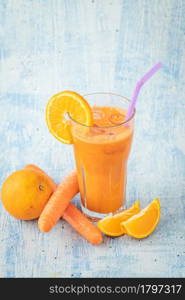 carrot and orange fresh juice on blue table