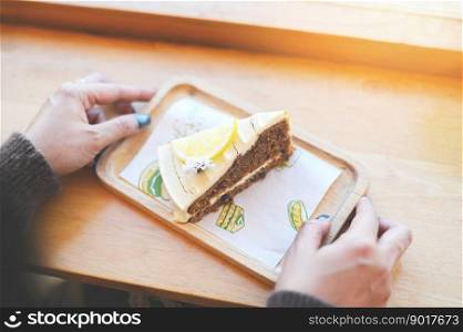 carrot cake on wooden plate, woman served carrot cake with lemon for dessert and tea - fresh homemade carrot cake cake slice