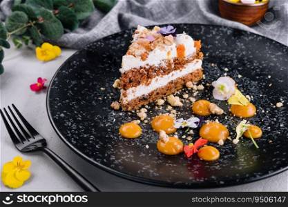 Carrot cake with walnuts on black plate