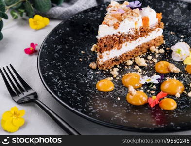 Carrot cake with walnuts on black plate