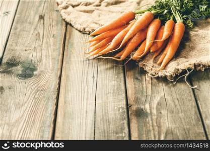 Carrot. Fresh Carrots bunch on rustic background. Raw fresh organic orange carrots. Healthy vegan vegetable food.