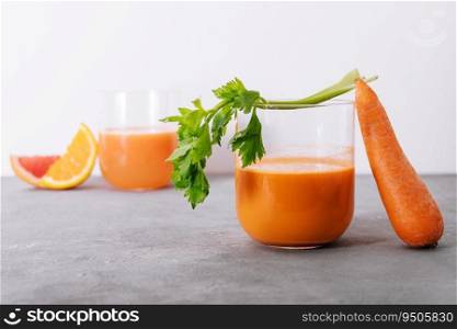 Carrot juice and fresh carrot closeup
