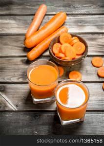 Carrot juice and pieces of carrots in a bowl. On wooden background. Carrot juice and pieces of carrots in a bowl.