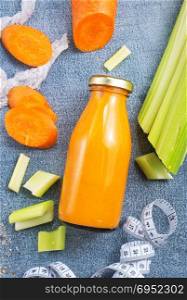 carrot smoothie with orange and cinnamon in glass jar and ingredients, detox drink
