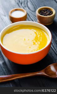 Carrot soup served on the table in bowl