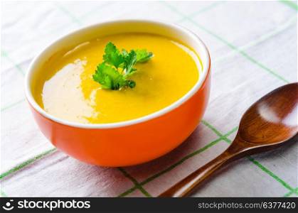 Carrot soup served on the table in bowl