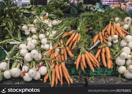 Carrots and onions in supermarket