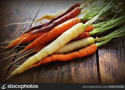 Carrots. Fresh colorful carrots on dark rustic background. Carrots. Fresh colorful carrots on dark rustic background.