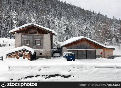 Cars, deep in snow, beside a alpine house, in Western Switzerland