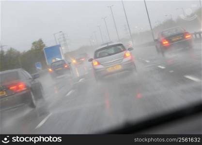 Cars Driving On A Rain Slicked Highway