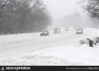 Cars driving on street in snow storm with headlights on. (08 February 2013, Mississauga, Ontario, Canada)