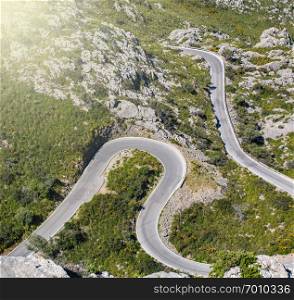 Cars driving popular among tourists beautiful winding mountain serpentine Coll dels Reis, Mallorca, Spain