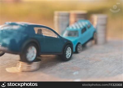 Cars Model coins stack on wooden table Finance insurance and Transportation concept