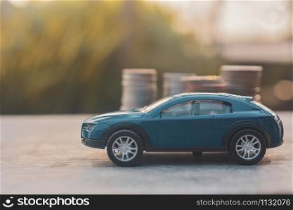 Cars Model coins stack on wooden table Finance insurance and Transportation concept
