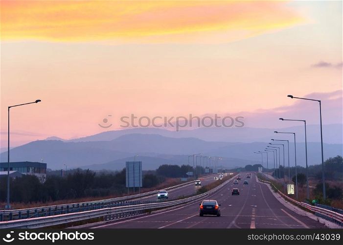 Cars on highway in the beautiful sunset