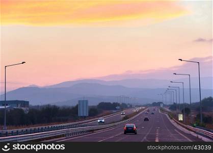 Cars on highway in the beautiful sunset