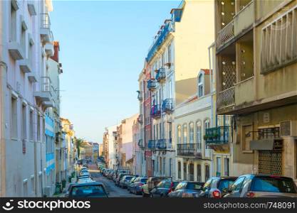 Cars parked at Old Town street of Lisbon, Portugal