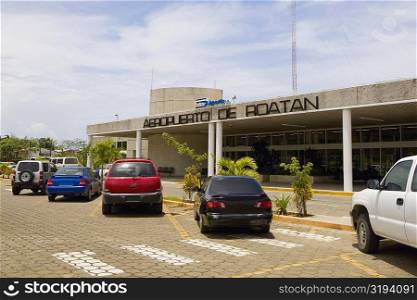 Cars parked in front of an airport entrance, Roatan, Bay Islands, Honduras