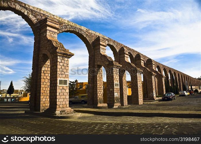 Cars parked near an aqueduct, Zacatecas State, Mexico