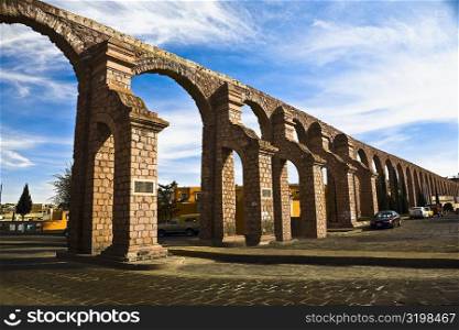Cars parked near an aqueduct, Zacatecas State, Mexico