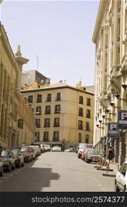 Cars parked on the street in front of buildings, Madrid, Spain
