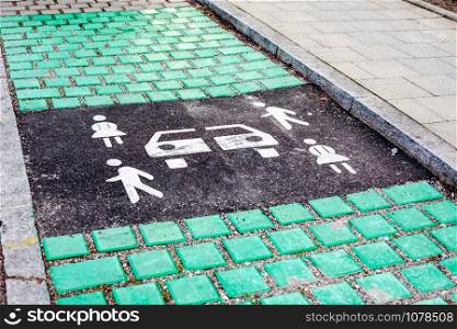 Carsharing vehicle parking sign on asphalt road of Munich, Germany, Europe. Modern rental ideology transport concept