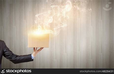Carton box in hand. Close up of businessman hand holding carton box