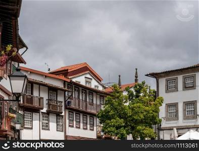 Carved balconies on traditional houses overlooking the main square in Guimaraes. Balconies of traditional houses in Guimaraes in Portugal